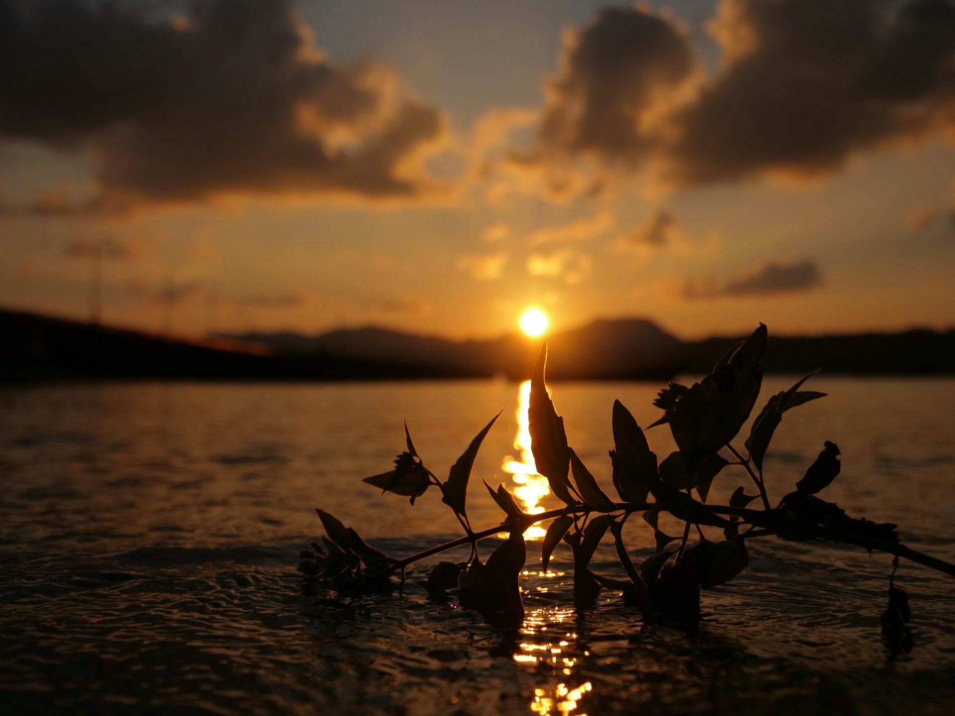 the sun is setting over a body of water